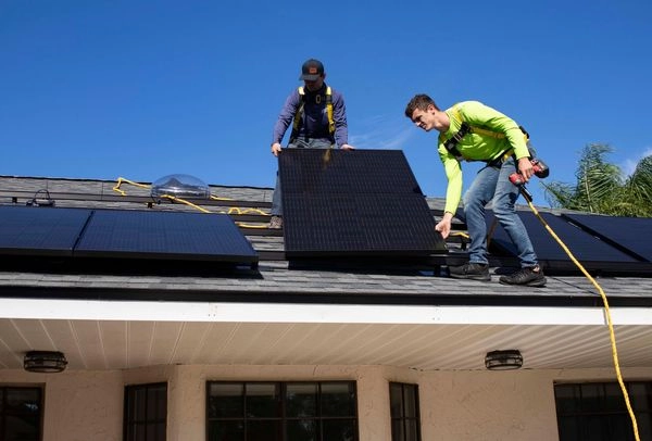 Installing solar panels on roof for sustainable alternatives.